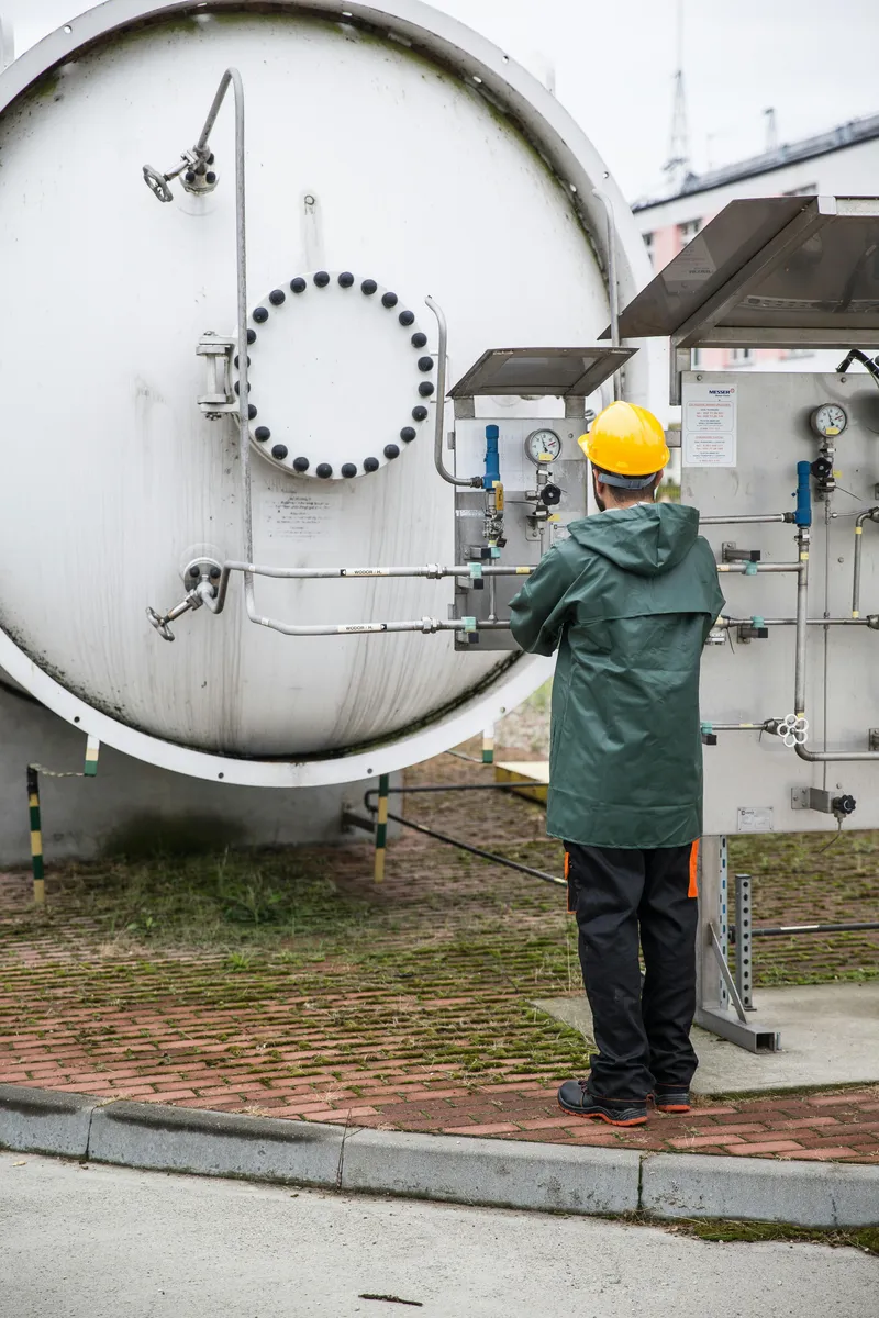 Field technician scanning NFC tag on water utility equipment outside in the field.